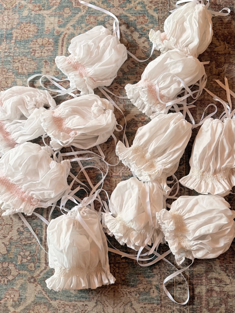 Lot of white smocked baby bonnets